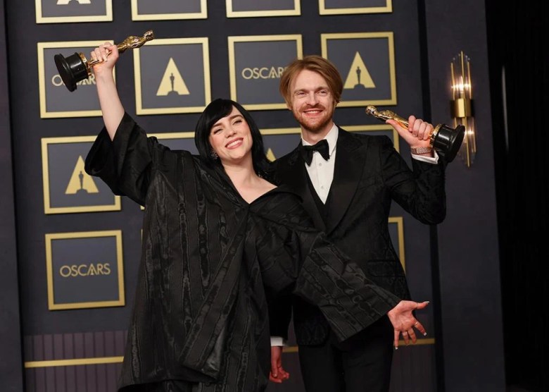 6. Billie Eilish's Sustainable Gucci Dress (2022) Billie Eilish and FINNEAS raising their Oscars statues in the press room during the 94th Annual Academy Awards at Hollywood and Highland on March 27, 2022 in Hollywood, California.
